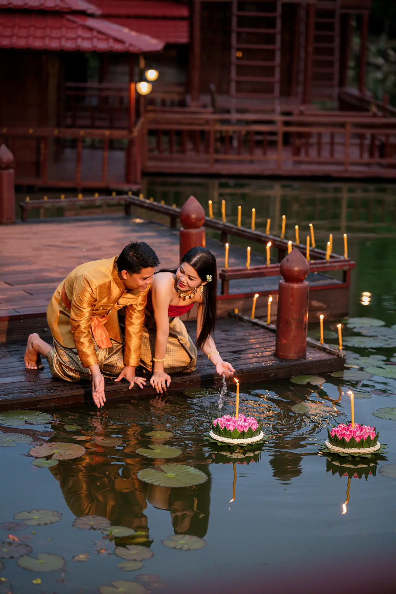 Candles and lotus offerings on the pond